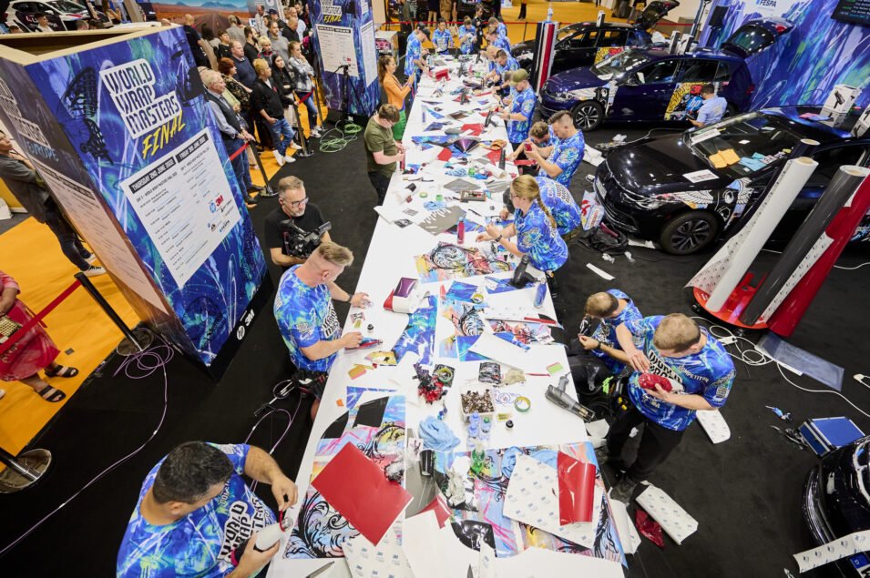 Overhead view of vehicle wrapping competitors preparing vinyl graphics at the FESPA Wrap Masters Final.