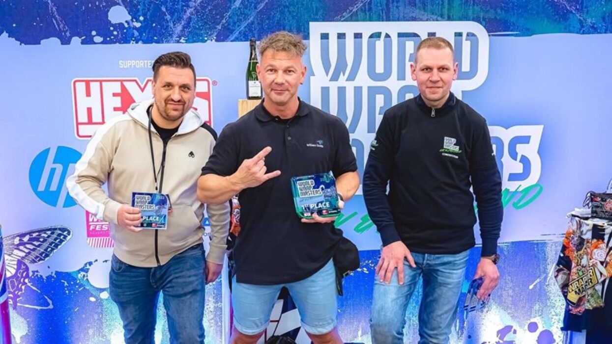 Three vehicle wrapping competitors, including the 1st place winner, pose with their World Wrap Masters awards.