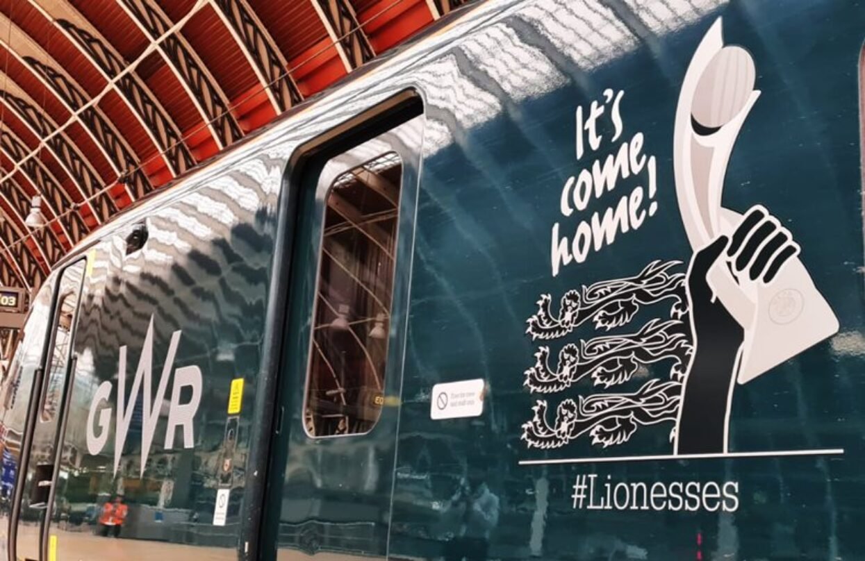 Dark green GWR train wrap celebrating the Lionesses, featuring the trophy, three lions, and "It's come home!".